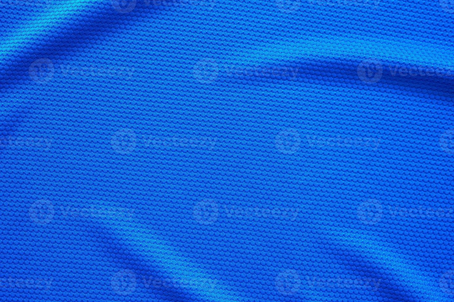 Blue football jersey clothing fabric texture sports wear background, close up top view photo