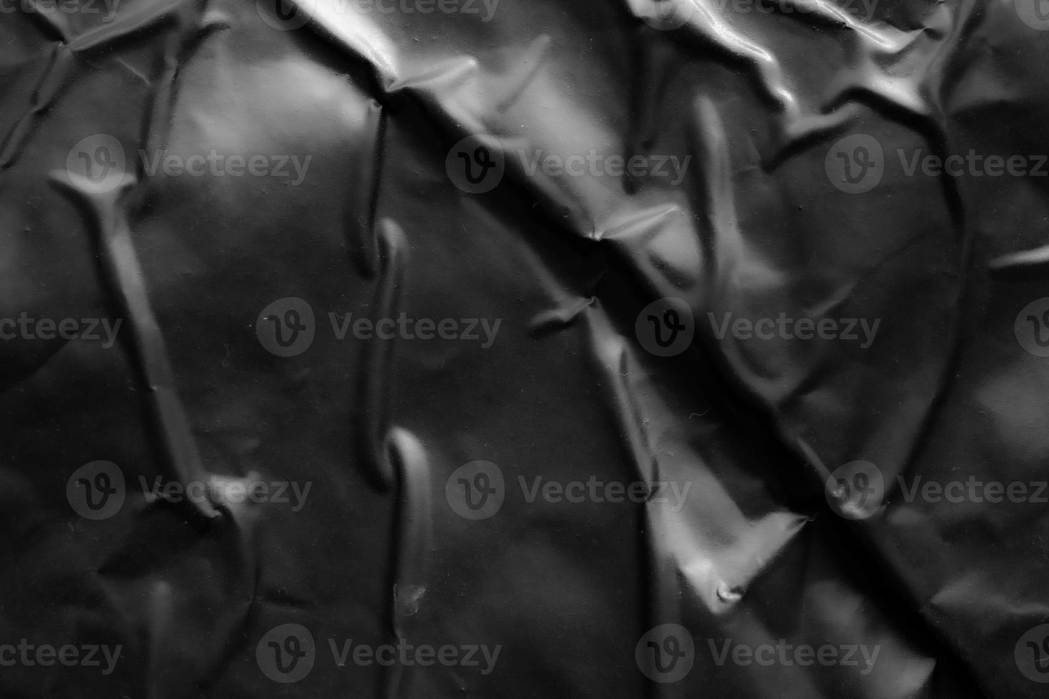 black crumpled and creased plastic poster texture background photo