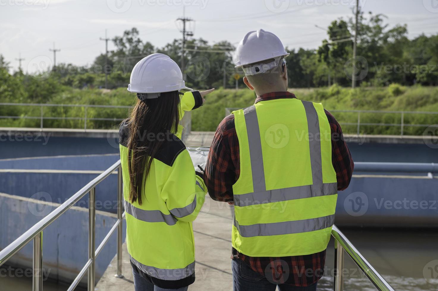 Environmental engineers work at wastewater treatment plants,Water supply engineering working at Water recycling plant for reuse,Technicians and engineers discuss work together. photo