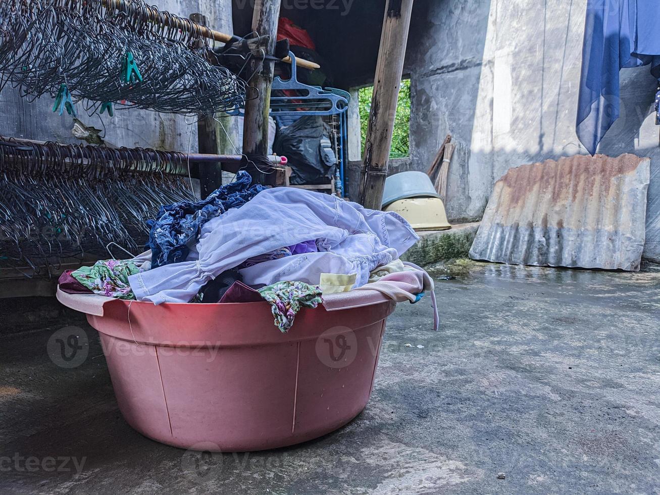 dirty laundry that has not been washed is piling up. a pile of dirty clothes that have not been washed for many days. Real life at the end of the year photo