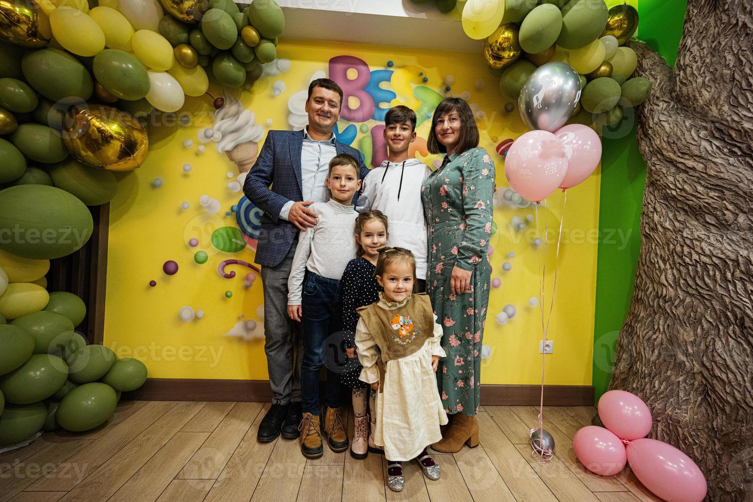 Family with four kids in child birthday party. photo