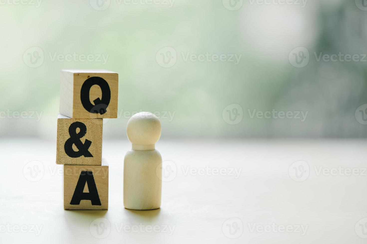Wooden blocks with the word FAQ, acronym frequently asked questions. photo