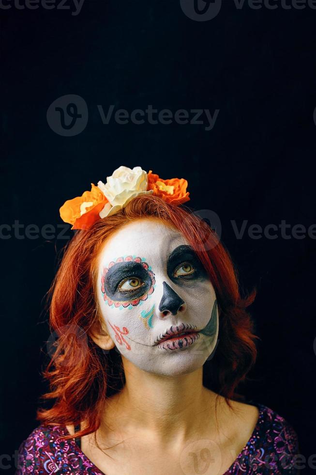 Young woman in day of the dead mask skull face art. photo