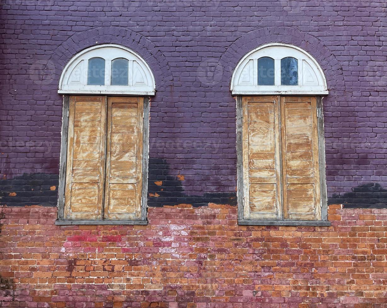Old church window and wall, Windows made of wood The upper window sill is a semicircular arch. The wall is made of bricks. Soft and selective focus. photo