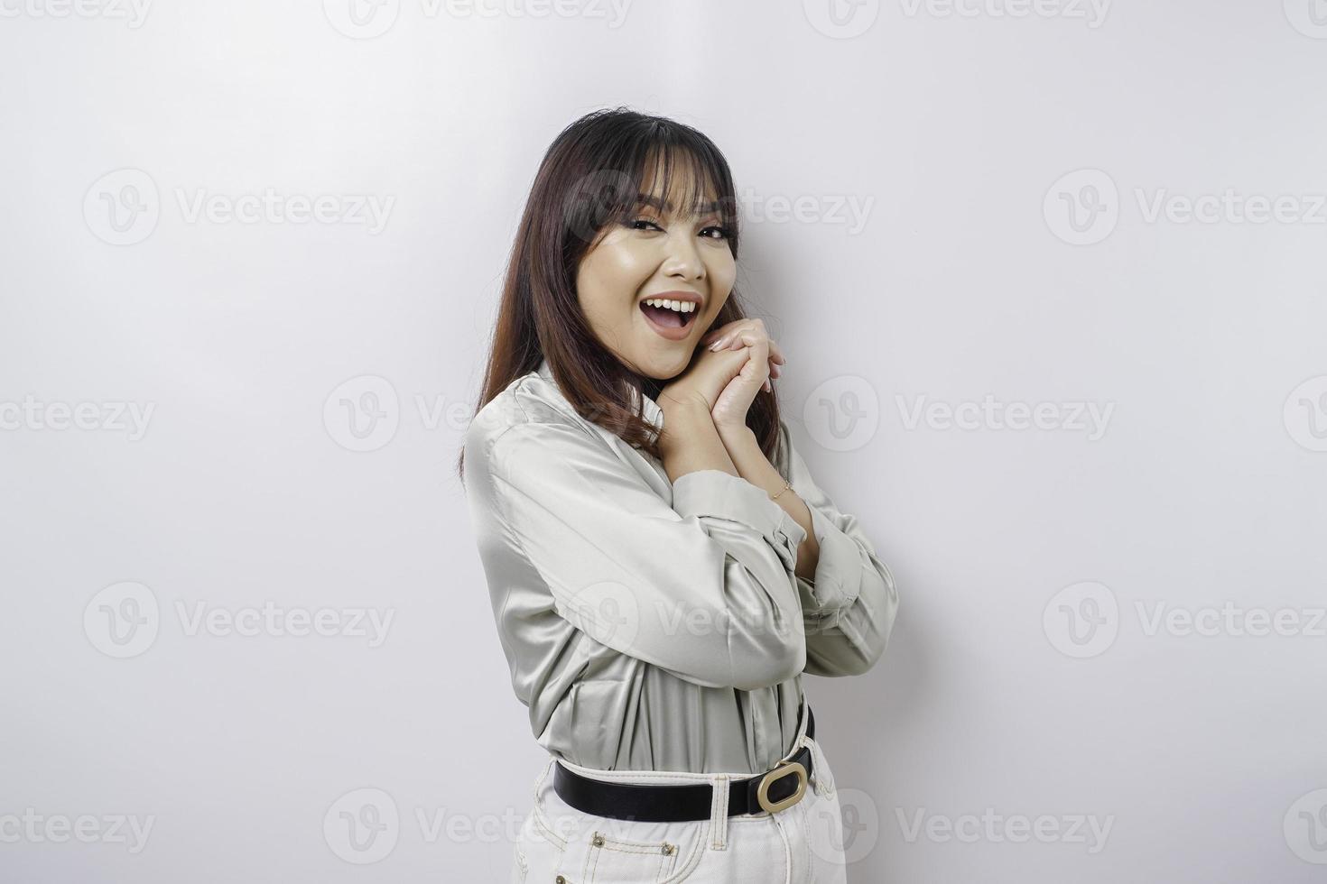 A portrait of a happy Asian woman wearing a sage green shirt isolated by white background photo