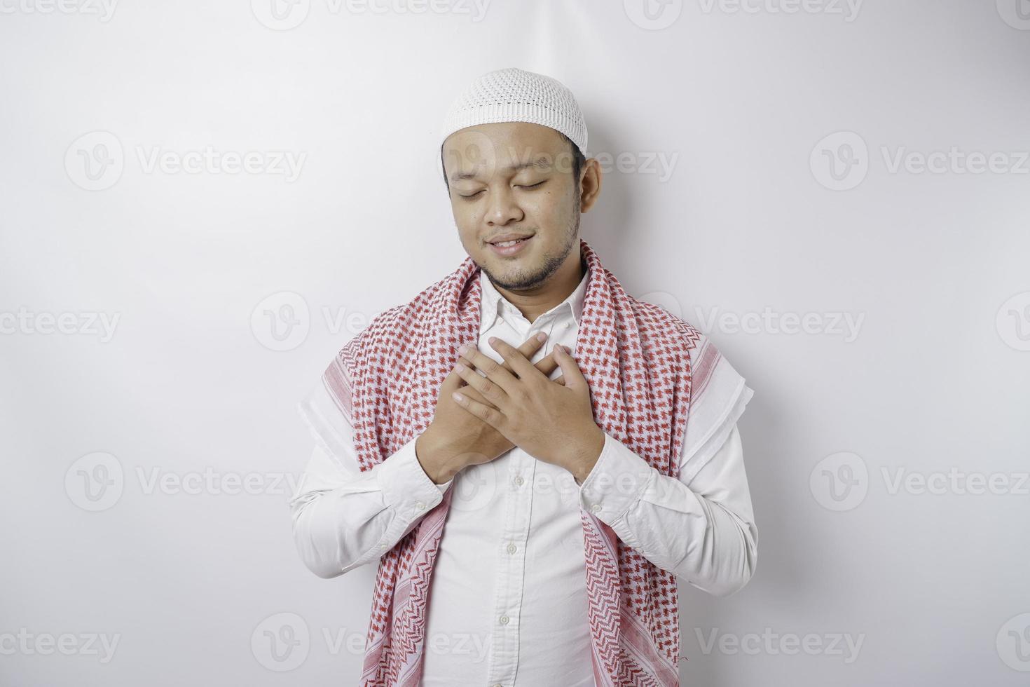 Portrait of a peaceful Asian Muslim man smiling and feel relief photo