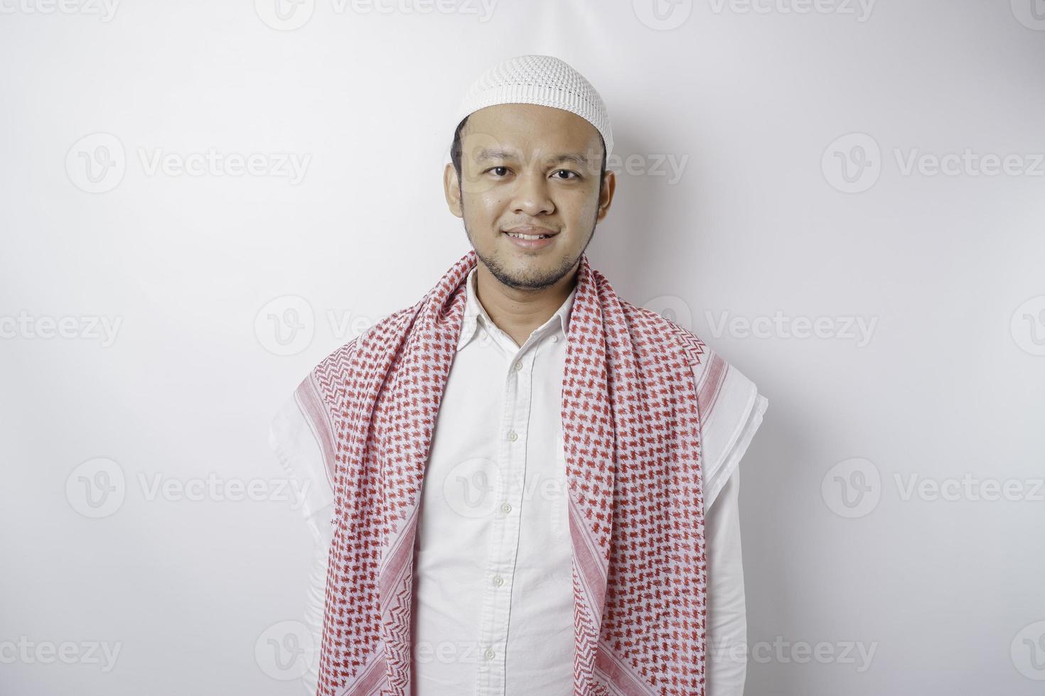 A portrait of a happy Asian Muslim man smiling isolated by white background photo