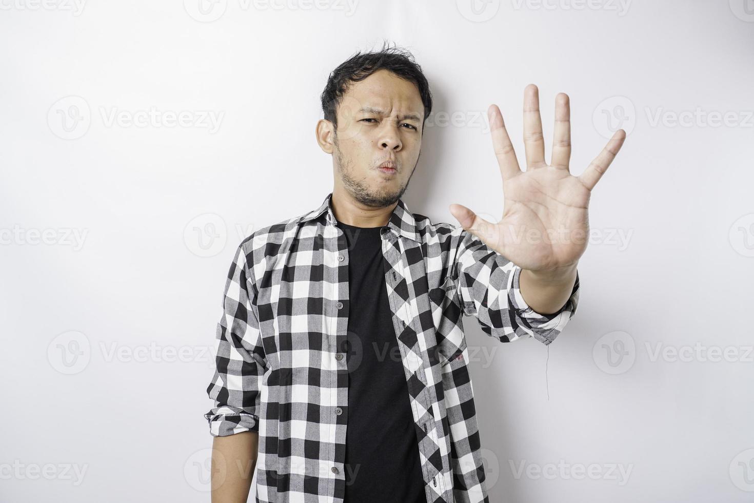 Handsome Asian man with hand gesture pose rejection or prohibition with copy space photo