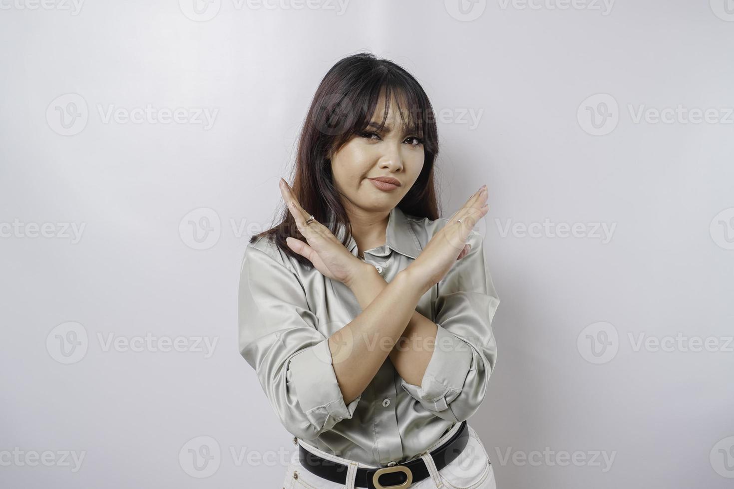 Beautiful Asian woman wearing sage green shirt with hand gesture pose rejection or prohibition with copy space photo