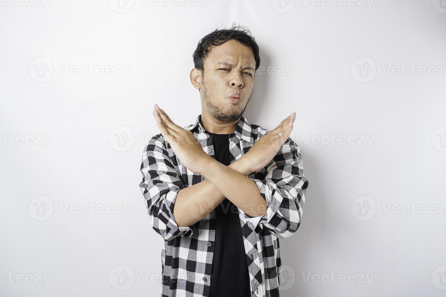 Handsome Asian man with hand gesture pose rejection or prohibition with copy space photo