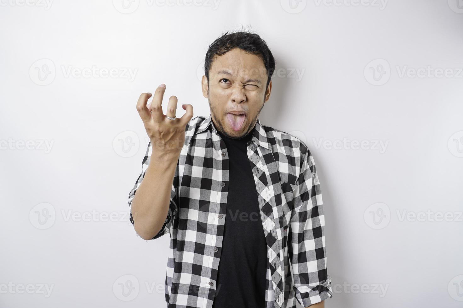 The angry and mad face of Asian man in tartan shirt on isolated white background. photo