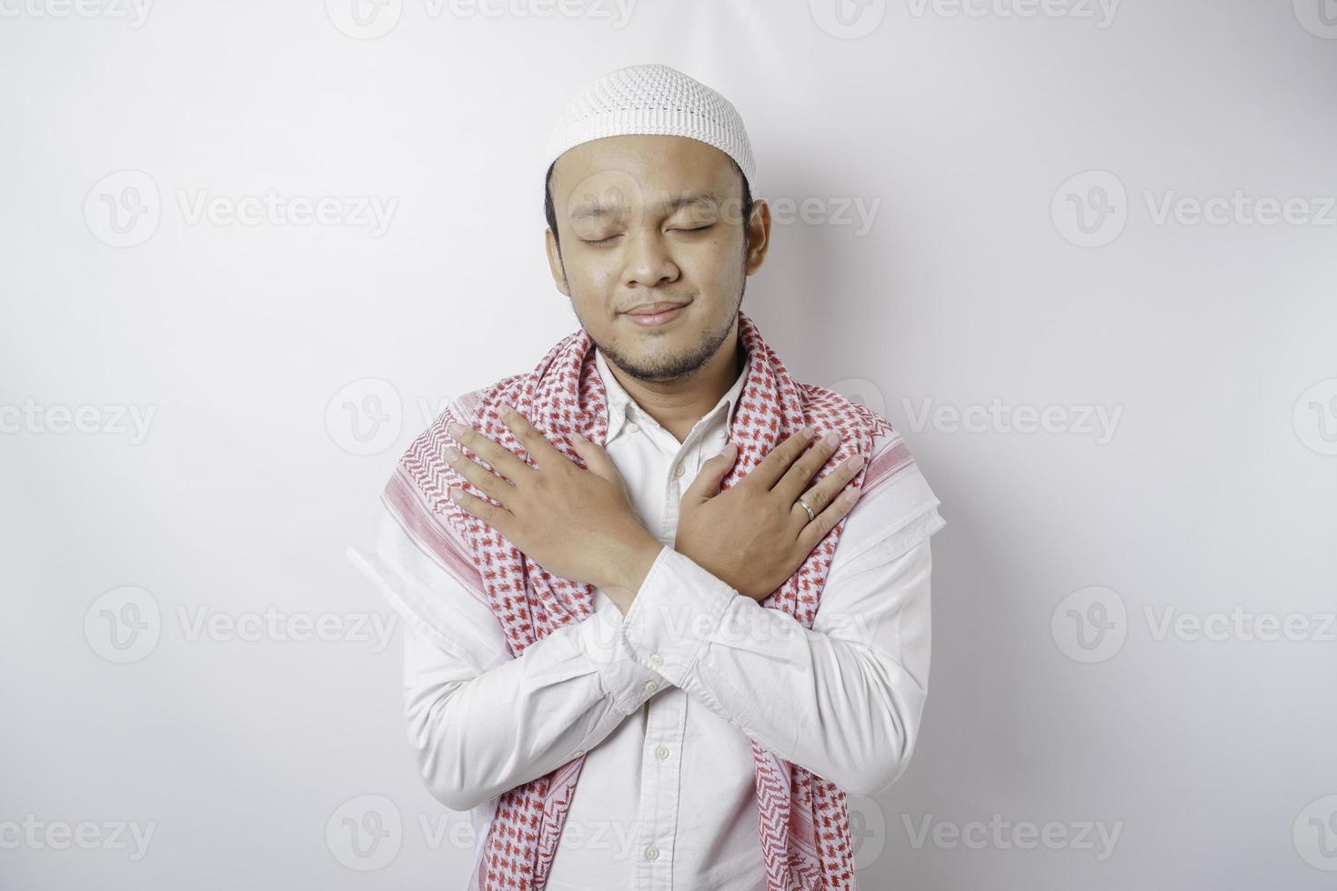 Portrait of a peaceful Asian Muslim man smiling and feel relief photo