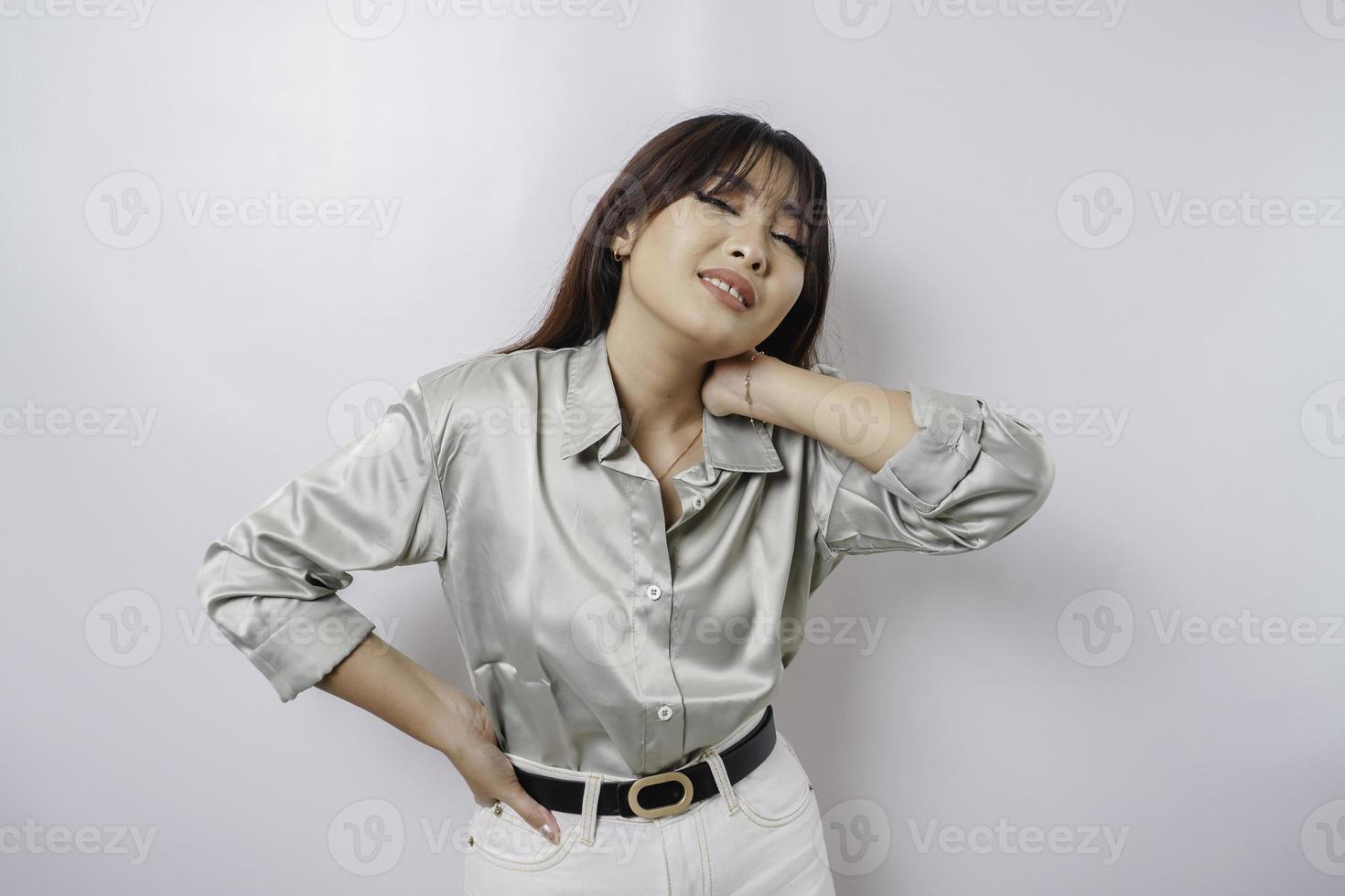 Tired upset young woman suffering from pain, muscle spasm at workplace. Fatigue, deadline, pain and incorrect posture photo
