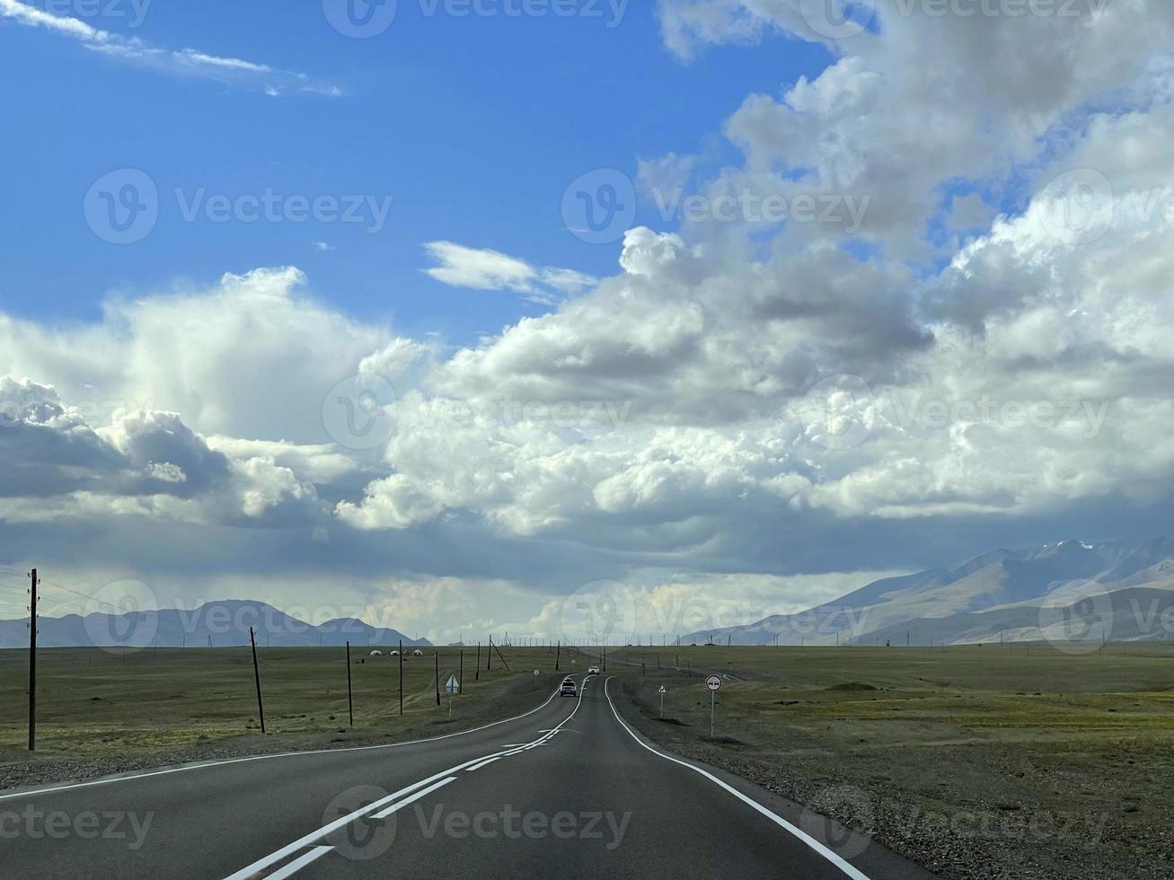 The road goes into the distance in the mountains, a part of the Chuisky tract , Altai, Russia photo