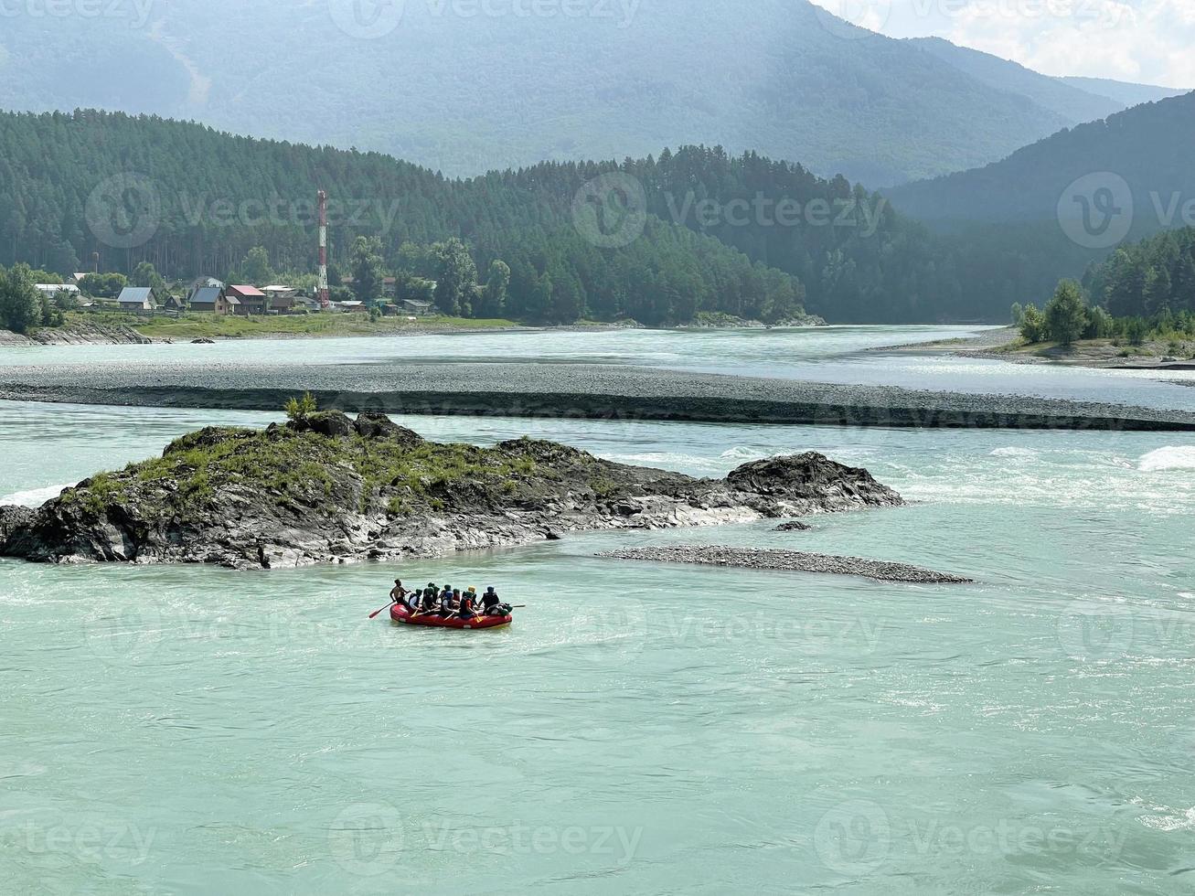People on a catamaran are rafting down the Katun River, Altai, Russia photo