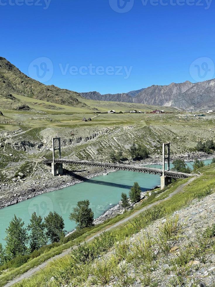 Old bridge across the Katun river in the Inya village, Altai, Russia photo