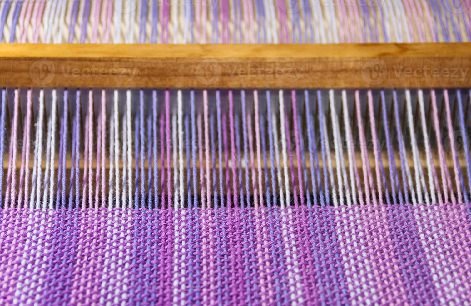 detail of fabric in comb loom with ultraviolet and lilac colors photo