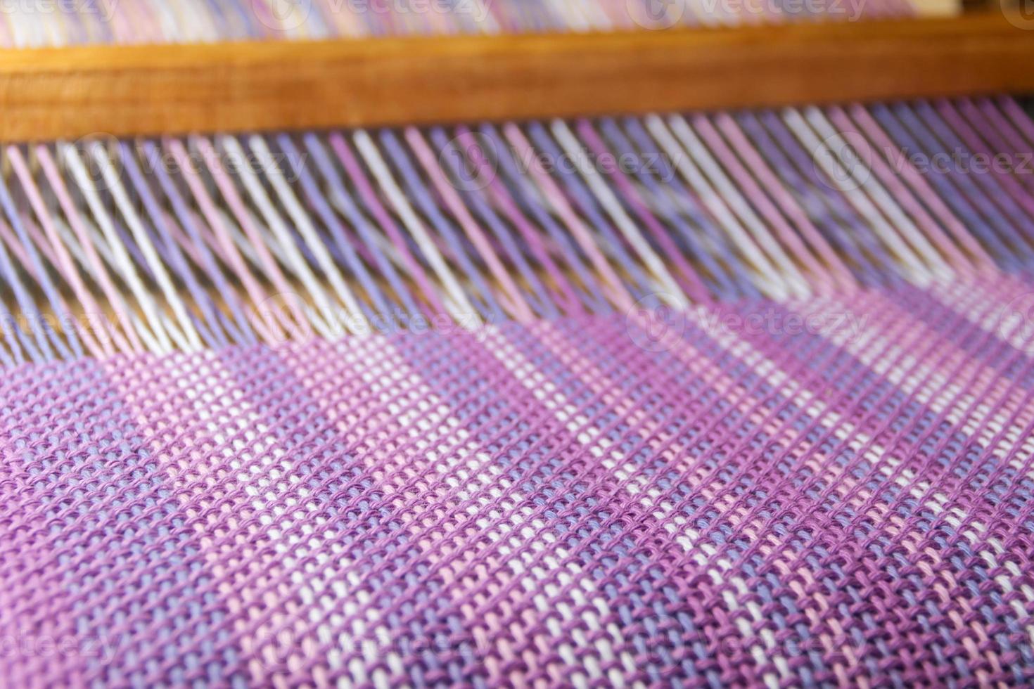 detail of fabric in comb loom with ultraviolet and lilac colors photo