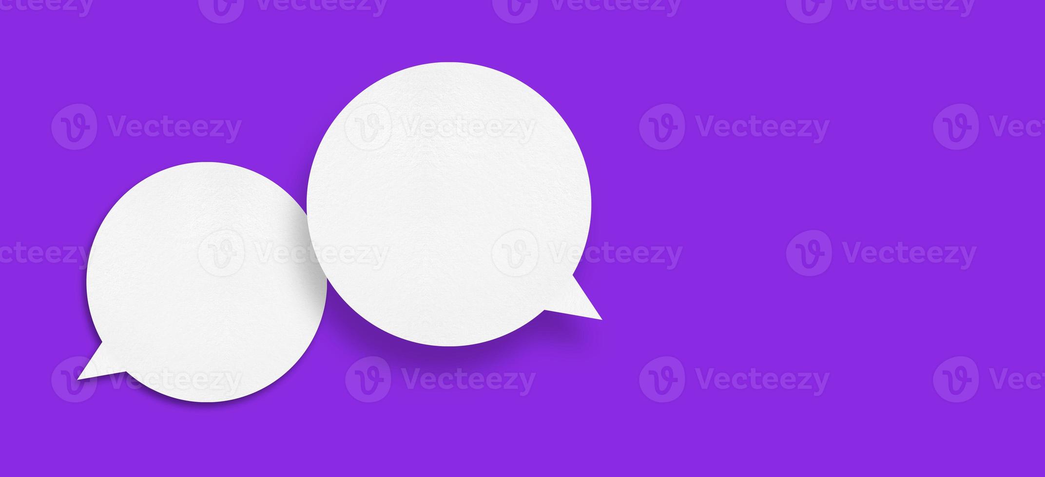 White paper in the shape of speech bubbles against a purple background. communication bubbles photo