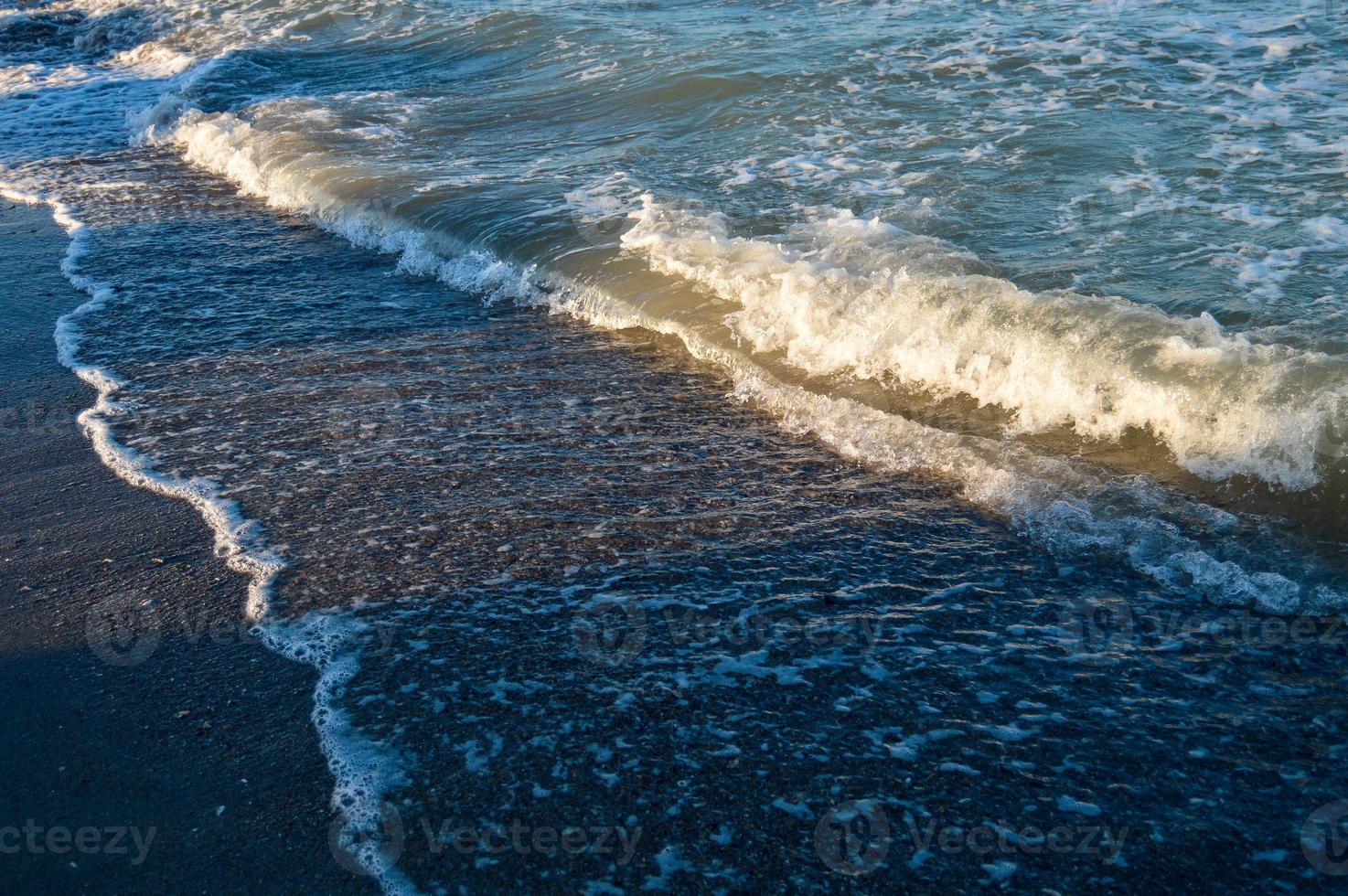 Seascape wave of the sea on the sandy beach photo
