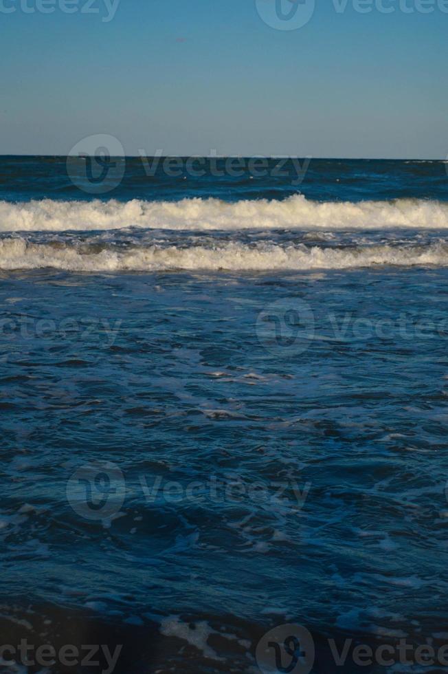 Seascape wave of the sea on the sandy beach photo