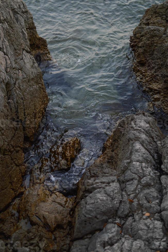 Rocks at the beach, calm water photo