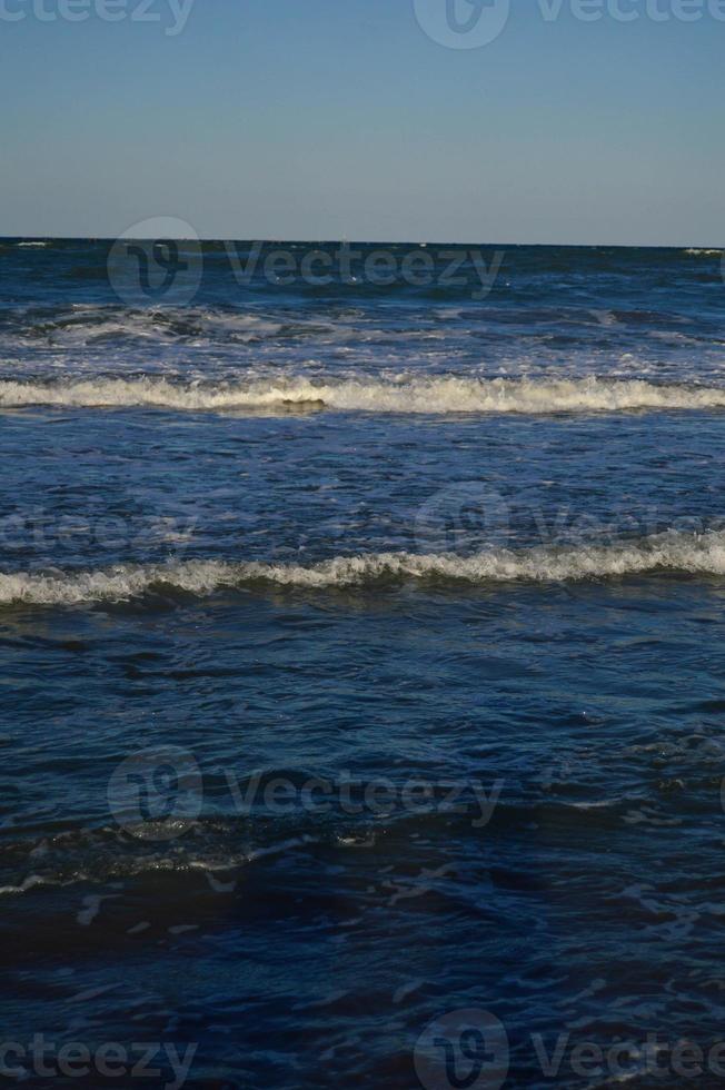 Seascape wave of the sea on the sandy beach photo