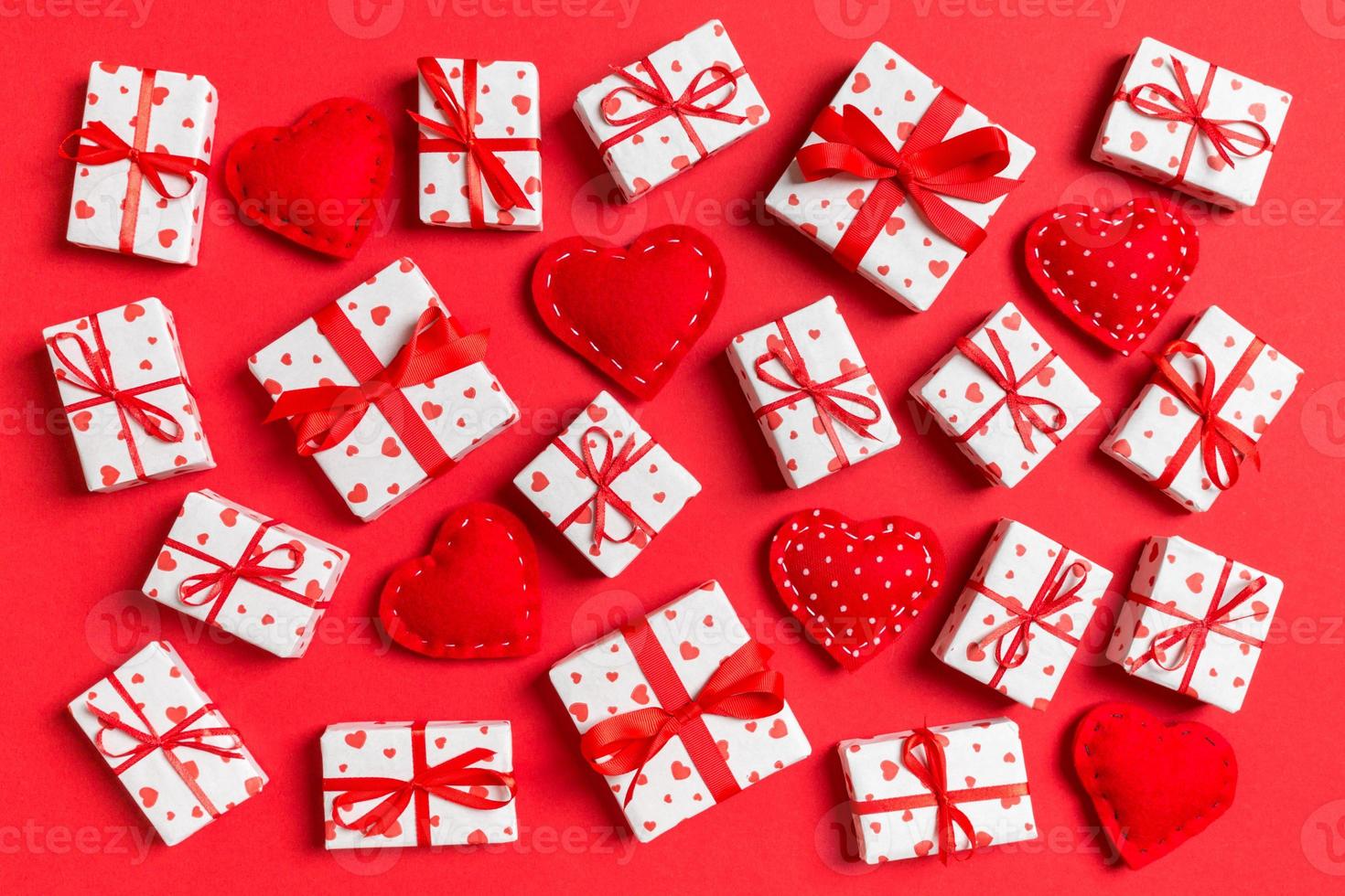 Top view of white gift boxes and red textile hearts on colorful background. Valentine's Day concept photo