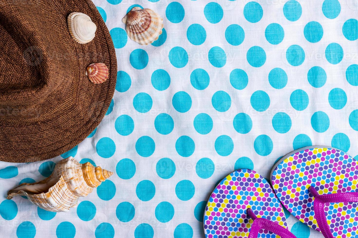 Summer holiday setting with flip-flops, Seashells and straw hat photo