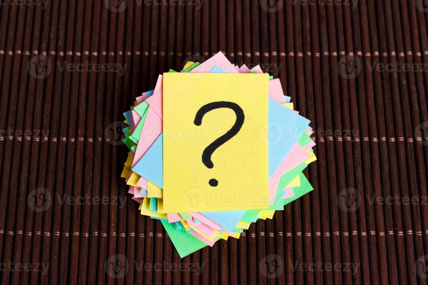 Concept for confusion, question or solution. question mark on wooden background photo