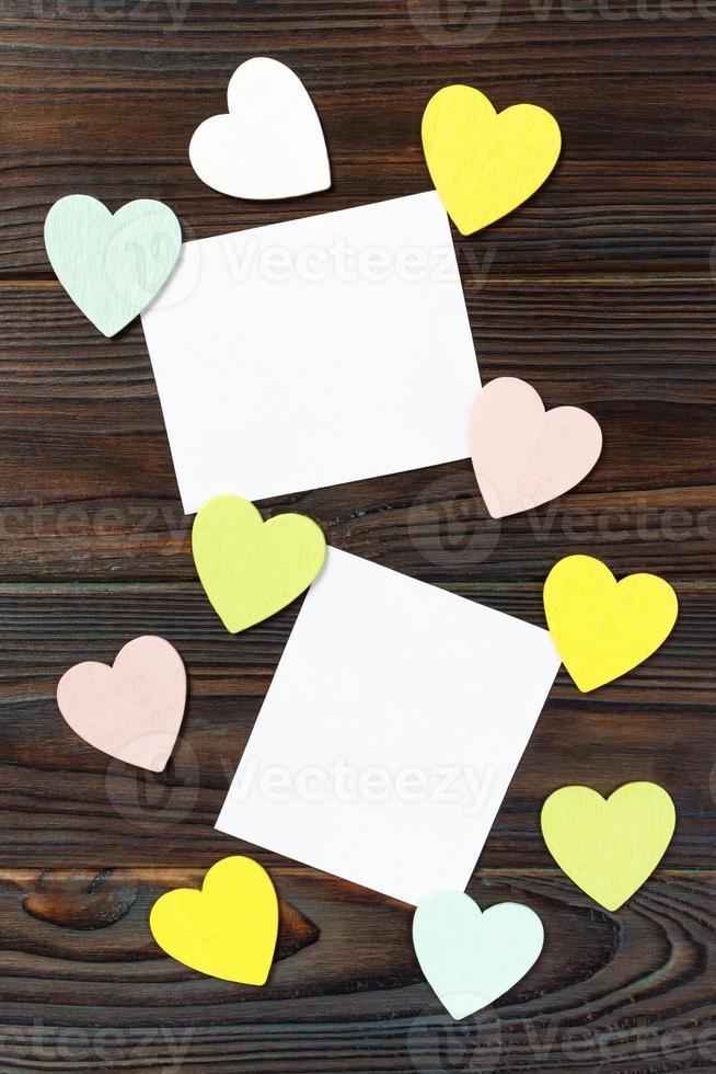 blank paper note with heart shape on grunge wooden background photo