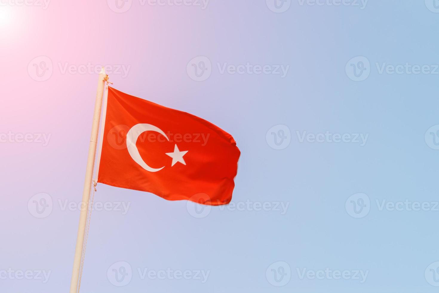 Turkish flag on the background of the sky in sunny day photo