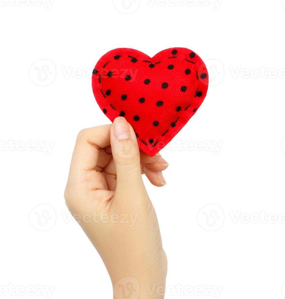 Hand holding a red heart isolated on white background photo