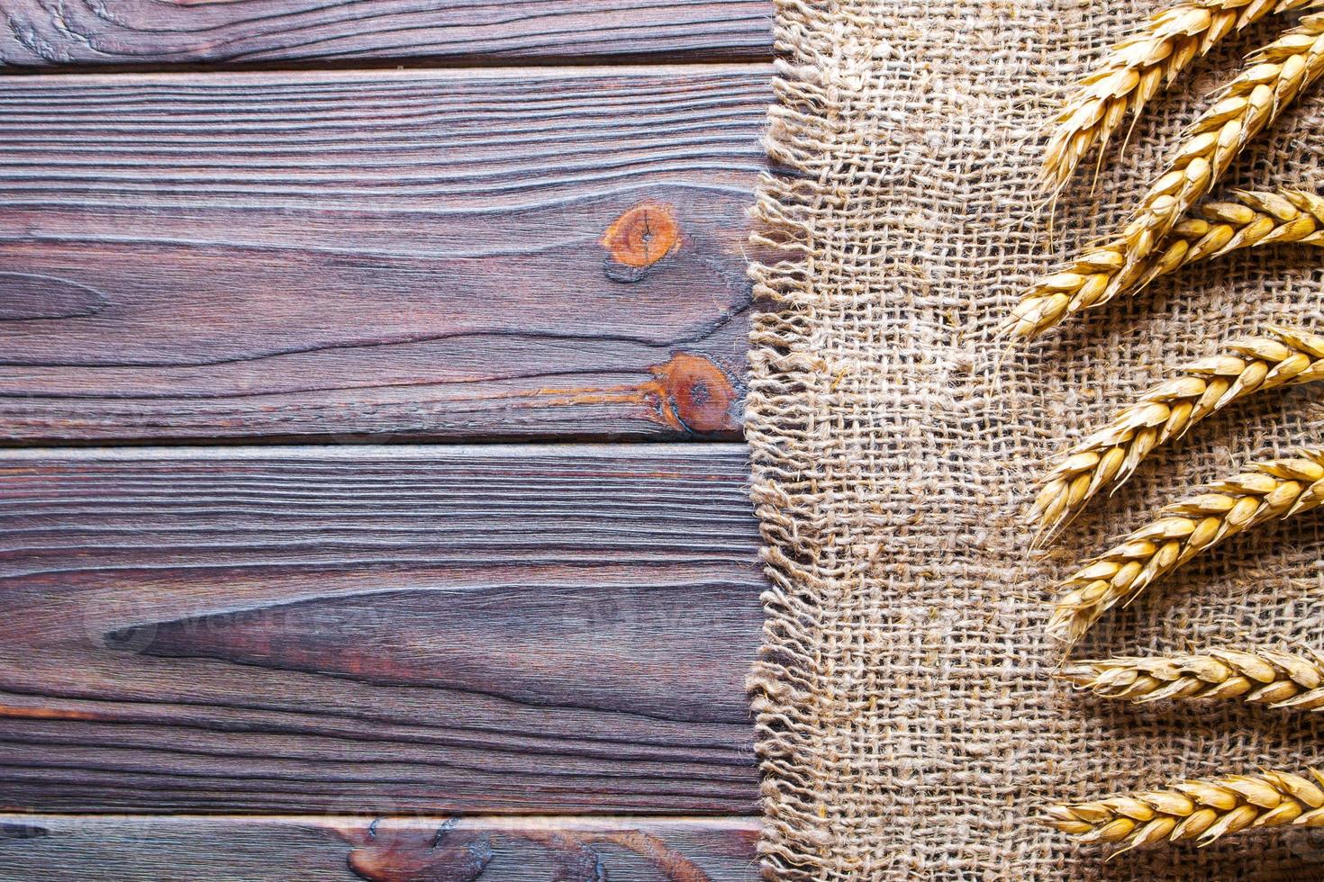 burlap hessian sacking on wooden background Harvest concept photo
