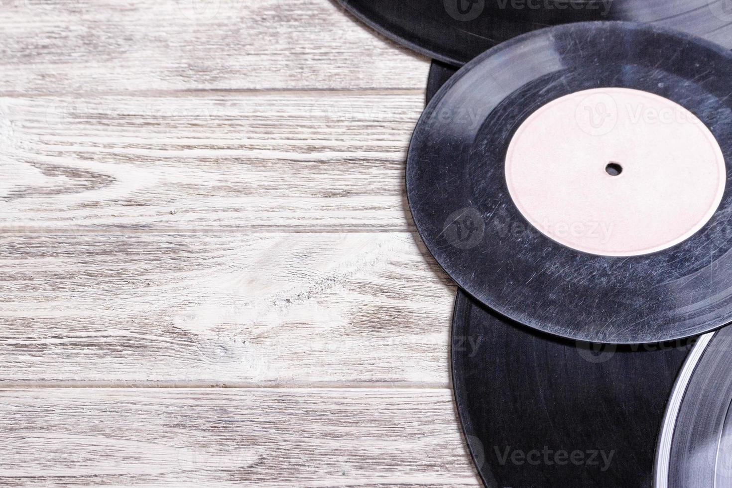 Scratched vinyl records on wooden background . Copy space for text. photo