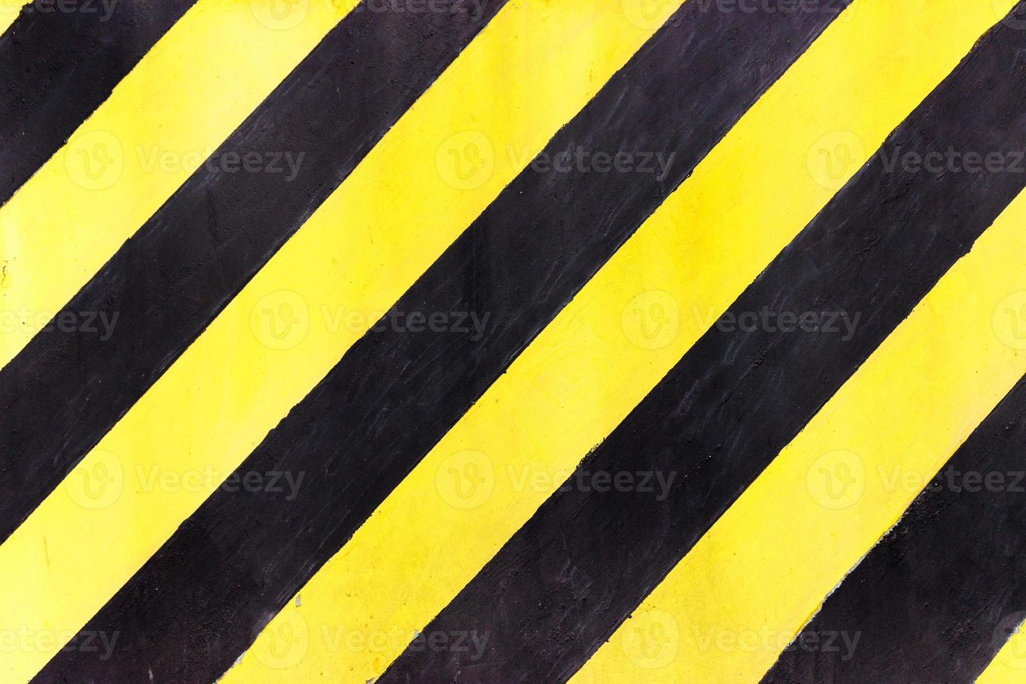 Safety stripes on construction site, Black and yellow Under construction sign over a grunge texture, top view photo