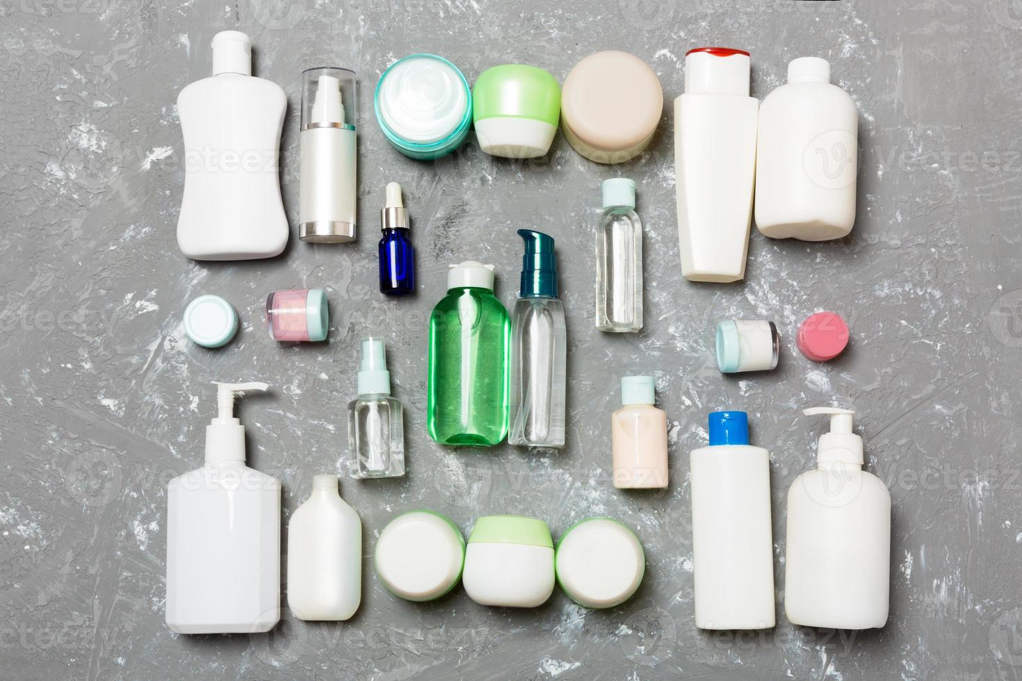 Group of plastic bodycare bottle Flat lay composition with cosmetic products on green background empty space for you design. Set of White Cosmetic containers, top view with copy space photo