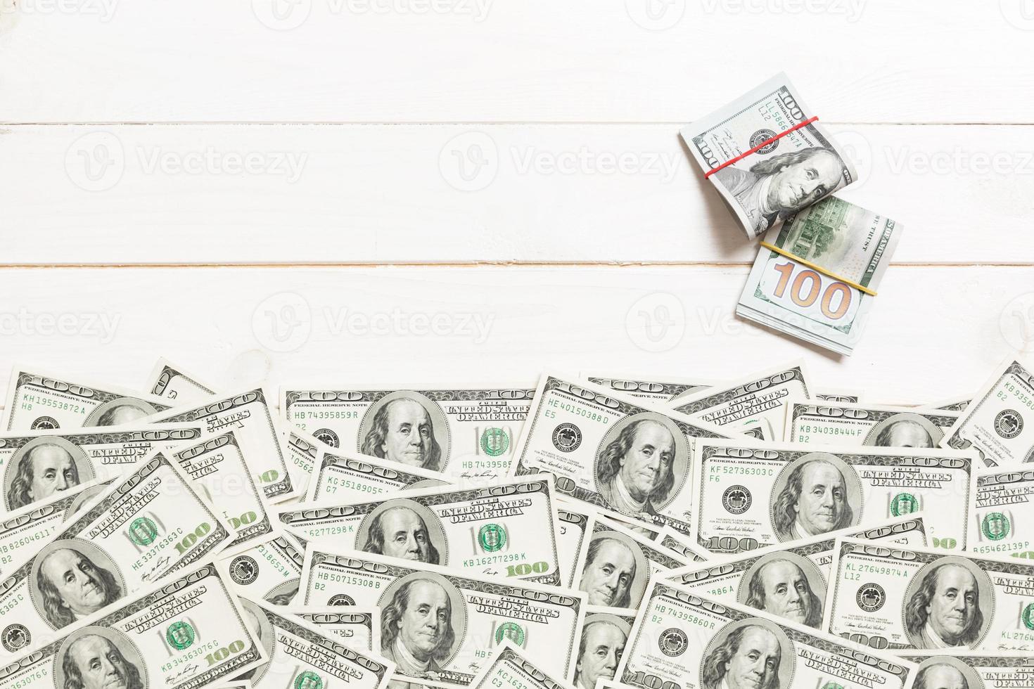 American money on colored background top view, with empty place for your text business money concept. One hundred dollar bills with stack of cash photo