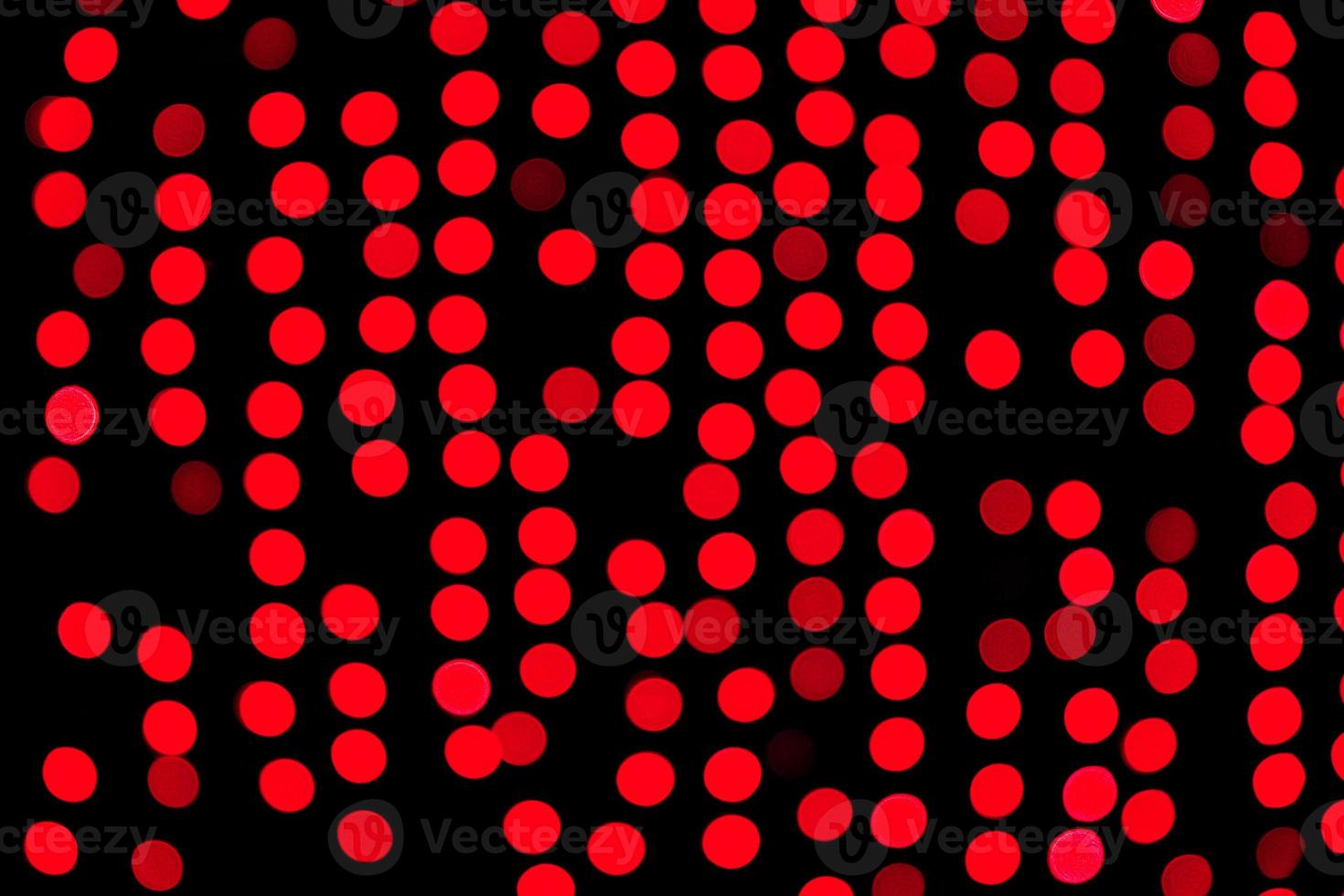 Unfocused abstract red bokeh on black background. defocused and blurred many round light photo