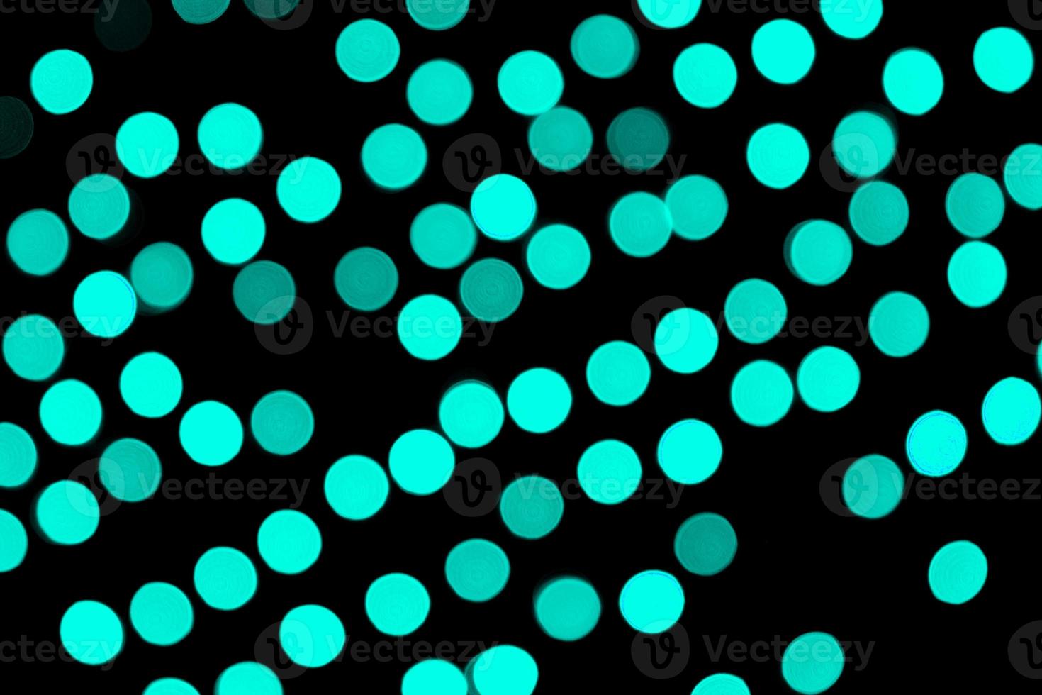 Unfocused abstract colourful bokeh black background. defocused and blurred many round blue light photo