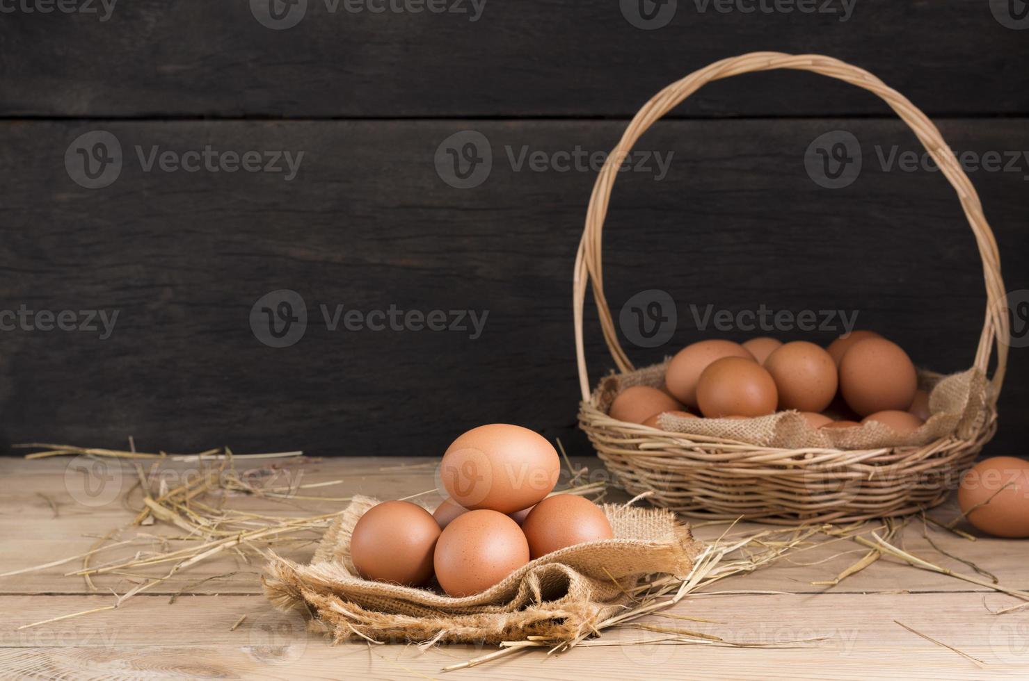 Fresh organic chicken eggs from the farm on a rustic wooden table. photo