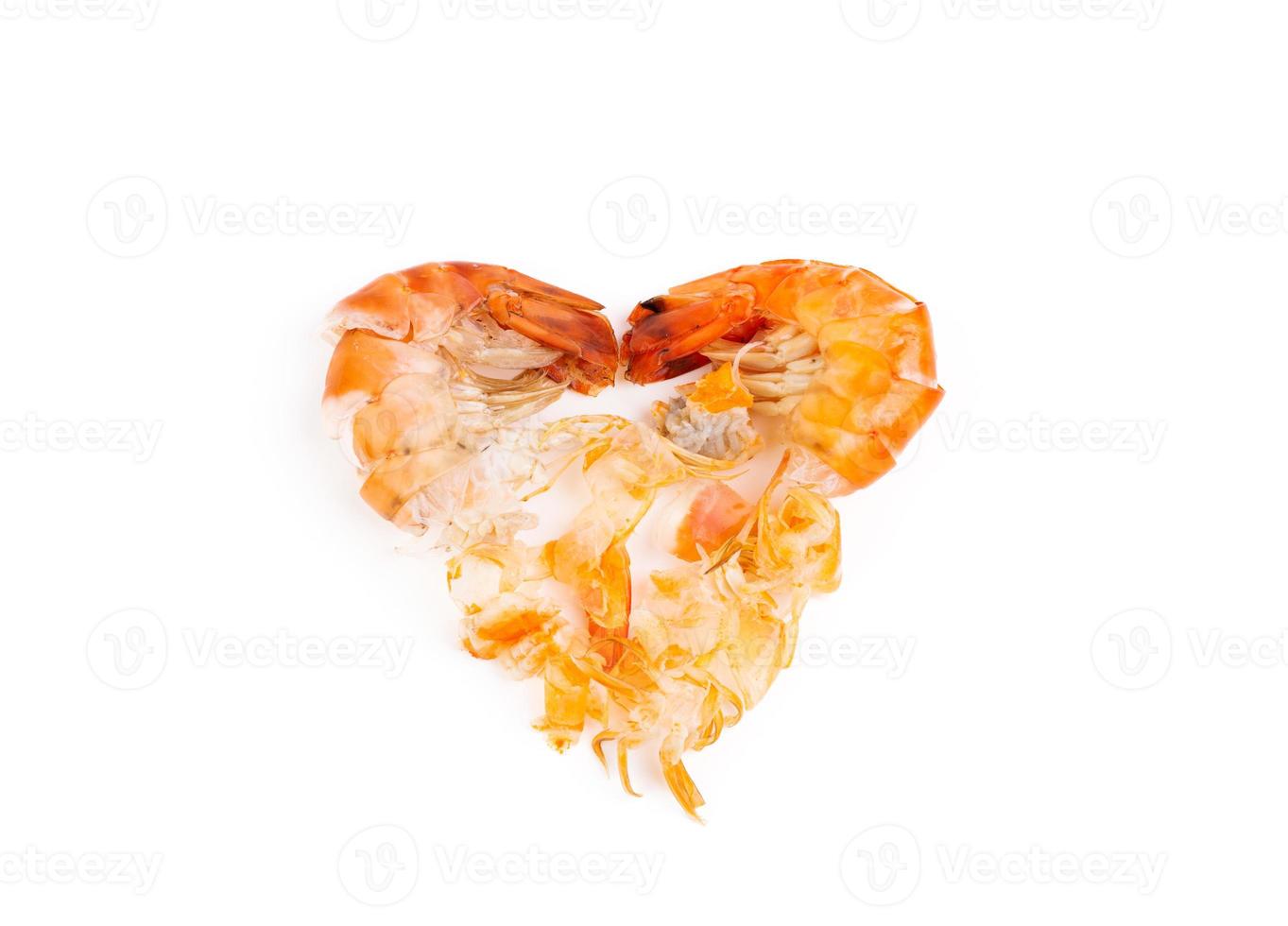 Heart shaped prawn heads and shells, scraps, leftovers, waste. Natural seafood. Lunch. Dinner isolated on white background. photo