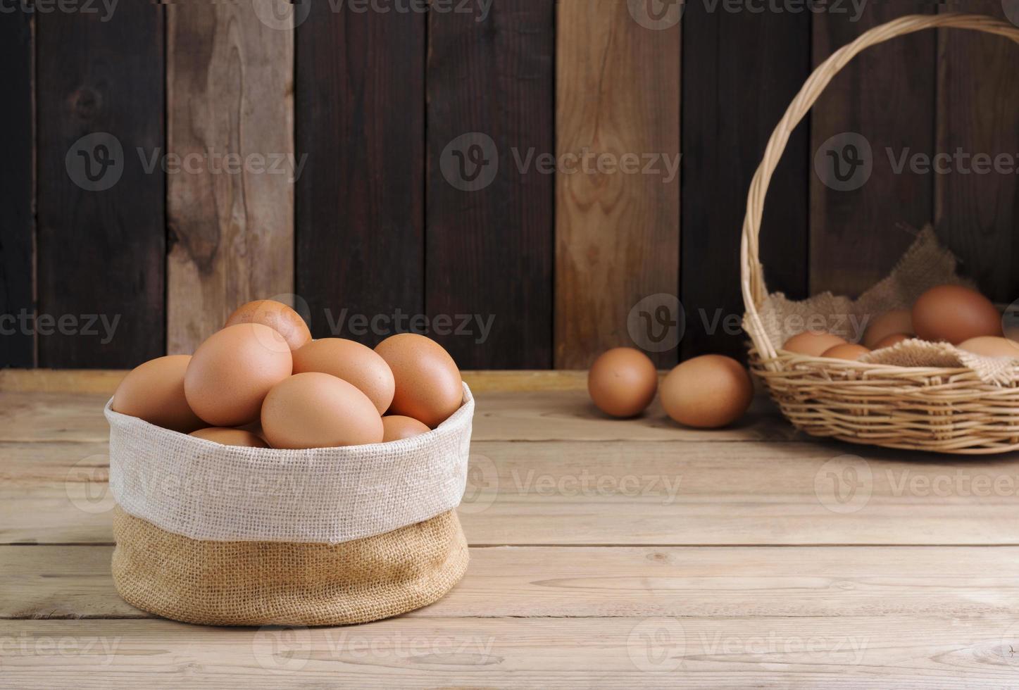 Fresh organic chicken eggs from the farm on a rustic wooden table. photo