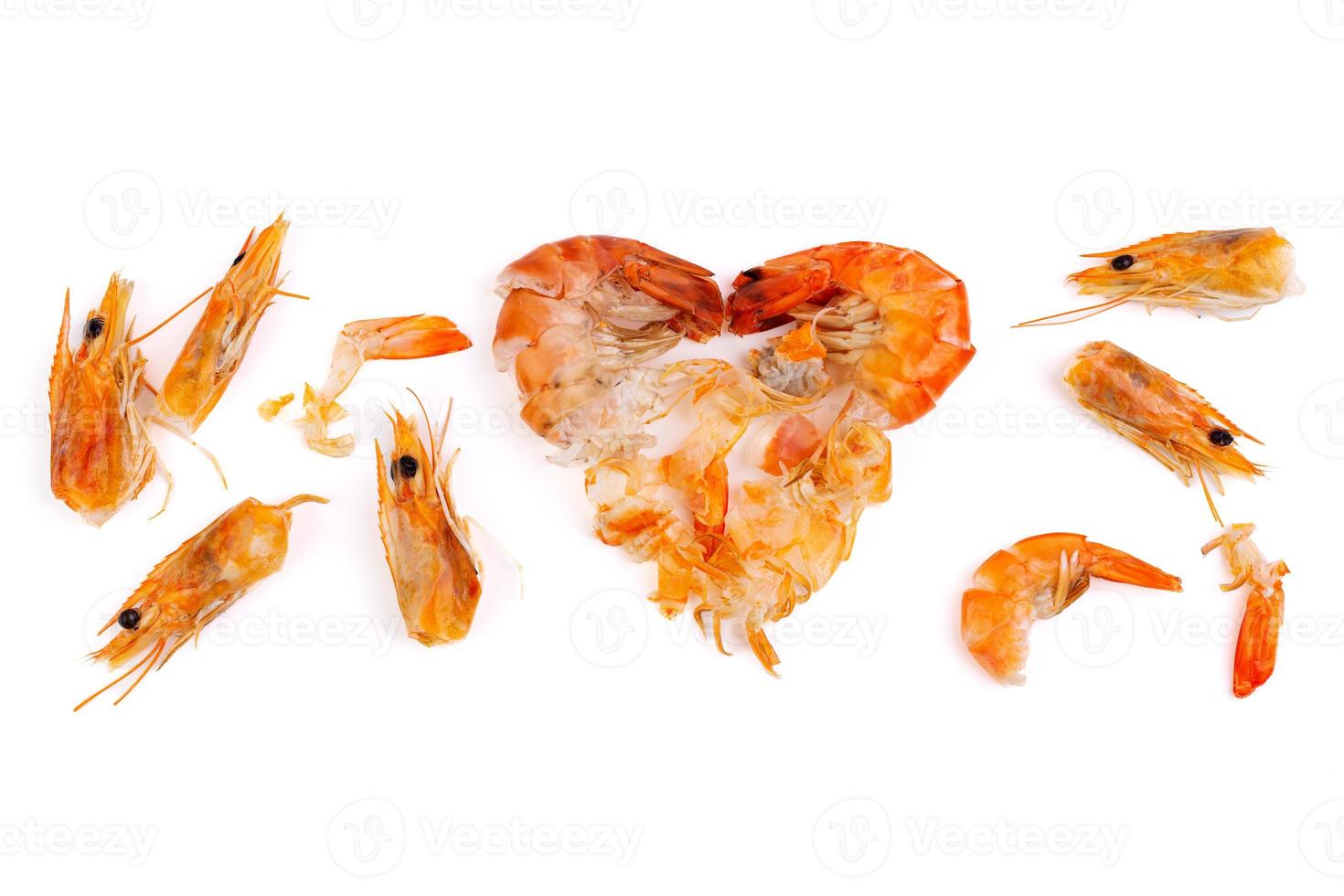 Heart shaped prawn heads and shells, scraps, leftovers, waste. Natural seafood. Lunch. Dinner isolated on white background. photo