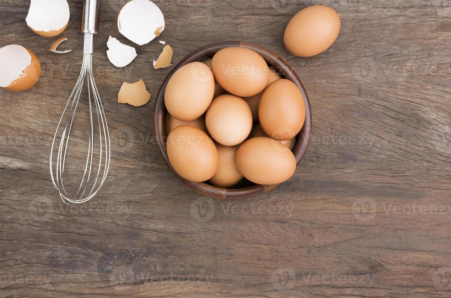 Farm fresh organic eggs laid on a rustic wooden table, top view. photo
