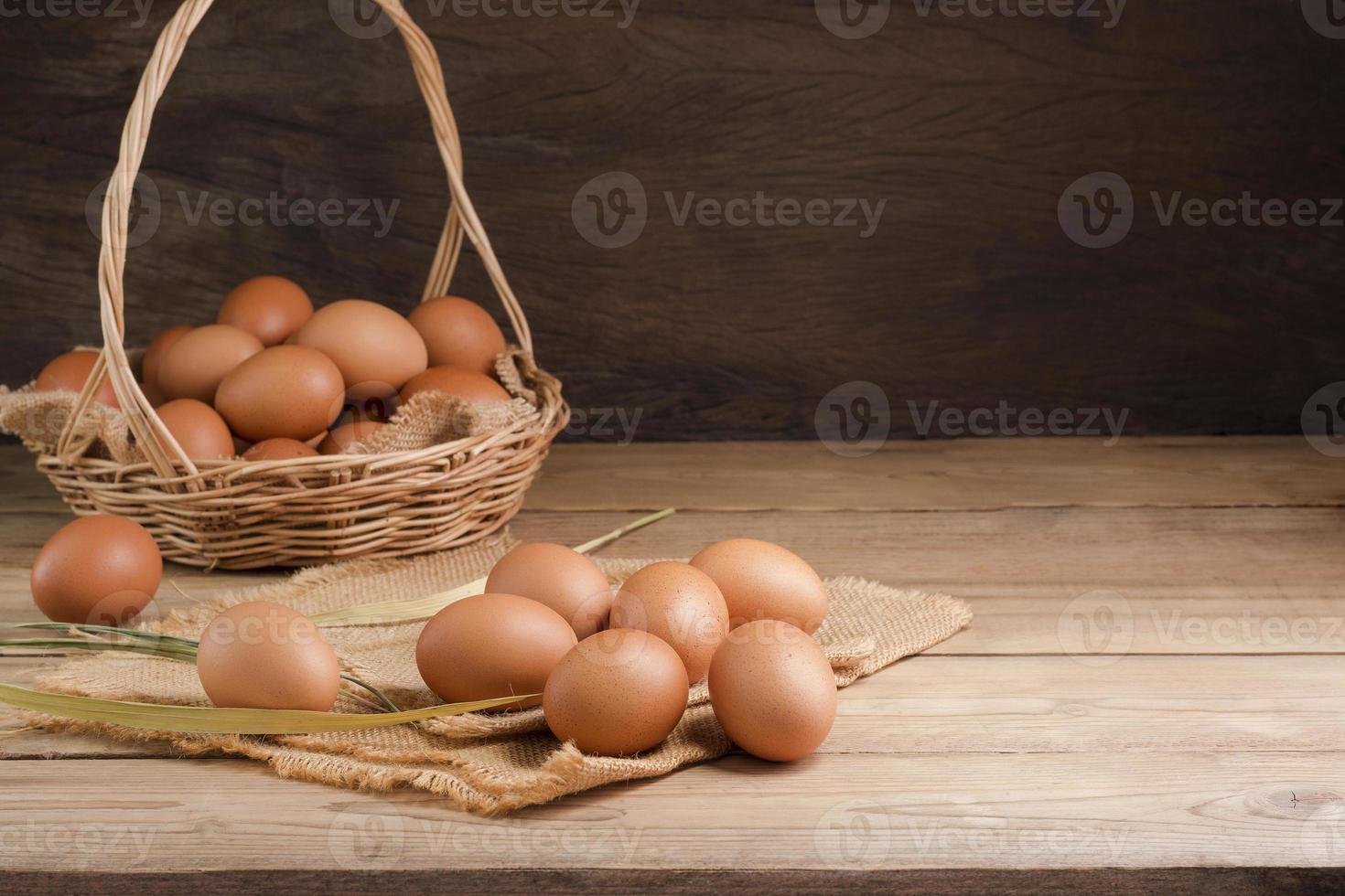 Fresh organic chicken eggs from the farm on a rustic wooden table. photo