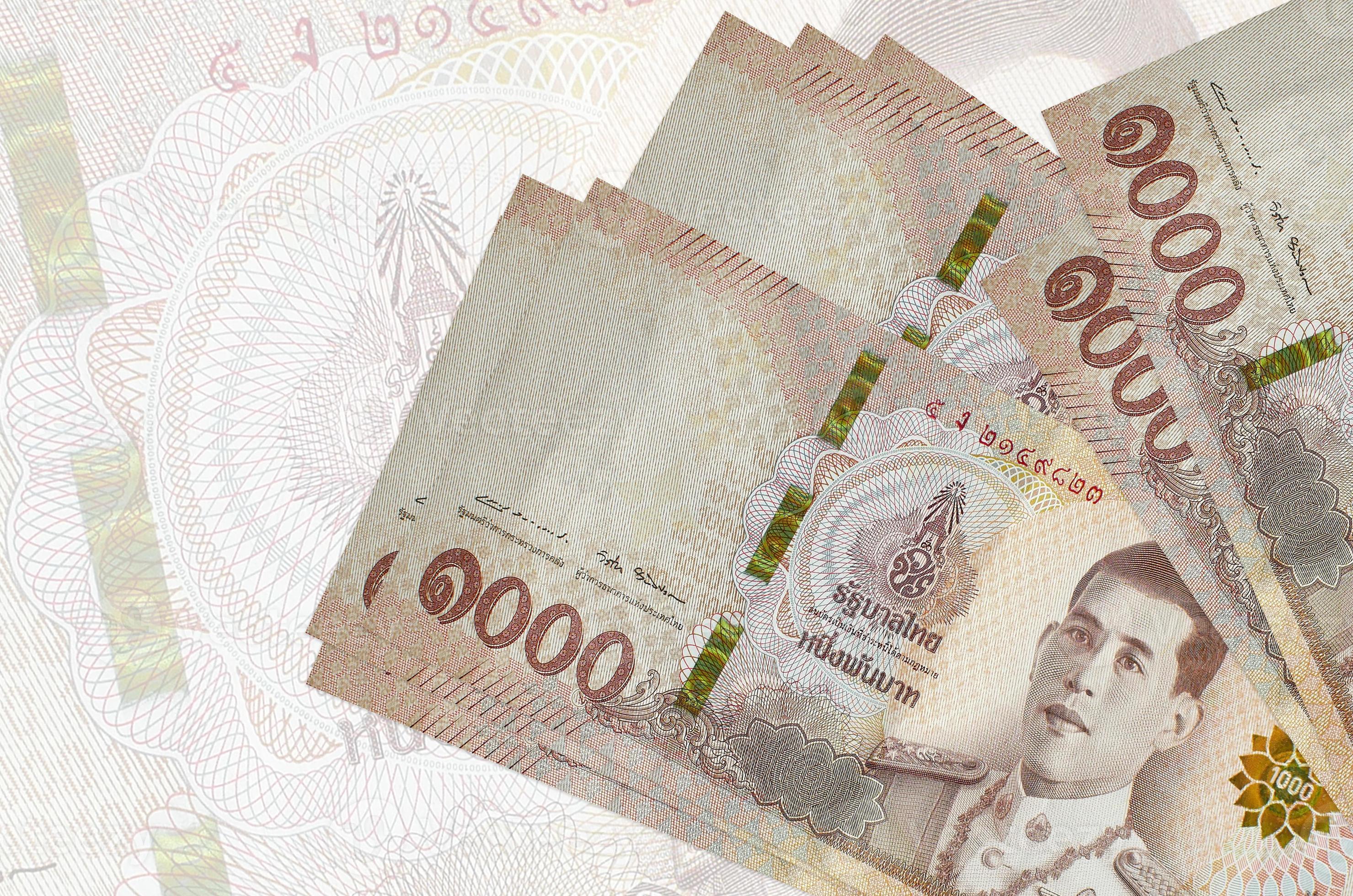 1000 Thai Baht Bills Lies In Stack On Background Of Big Semi 1000-thai-baht-bills-lies-in-stack-on-background-of-big-semi