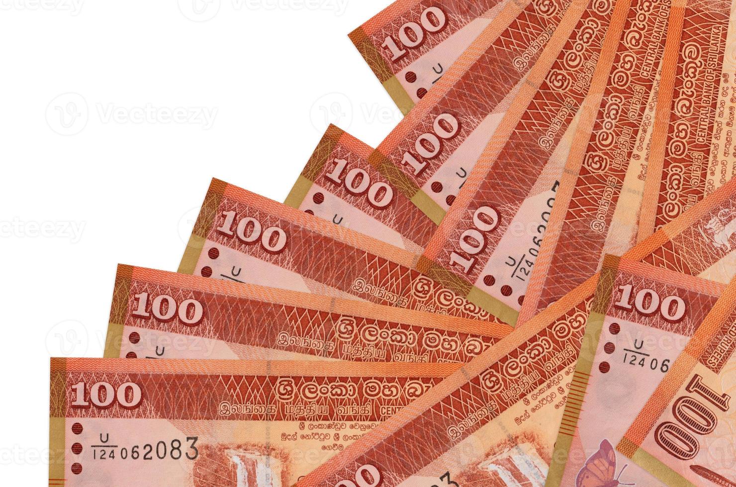 100 Sri Lankan rupees bills lies in different order isolated on white. Local banking or money making concept photo