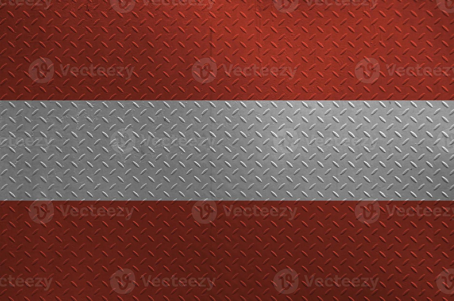 Austria flag depicted in paint colors on old brushed metal plate or wall closeup. Textured banner on rough background photo
