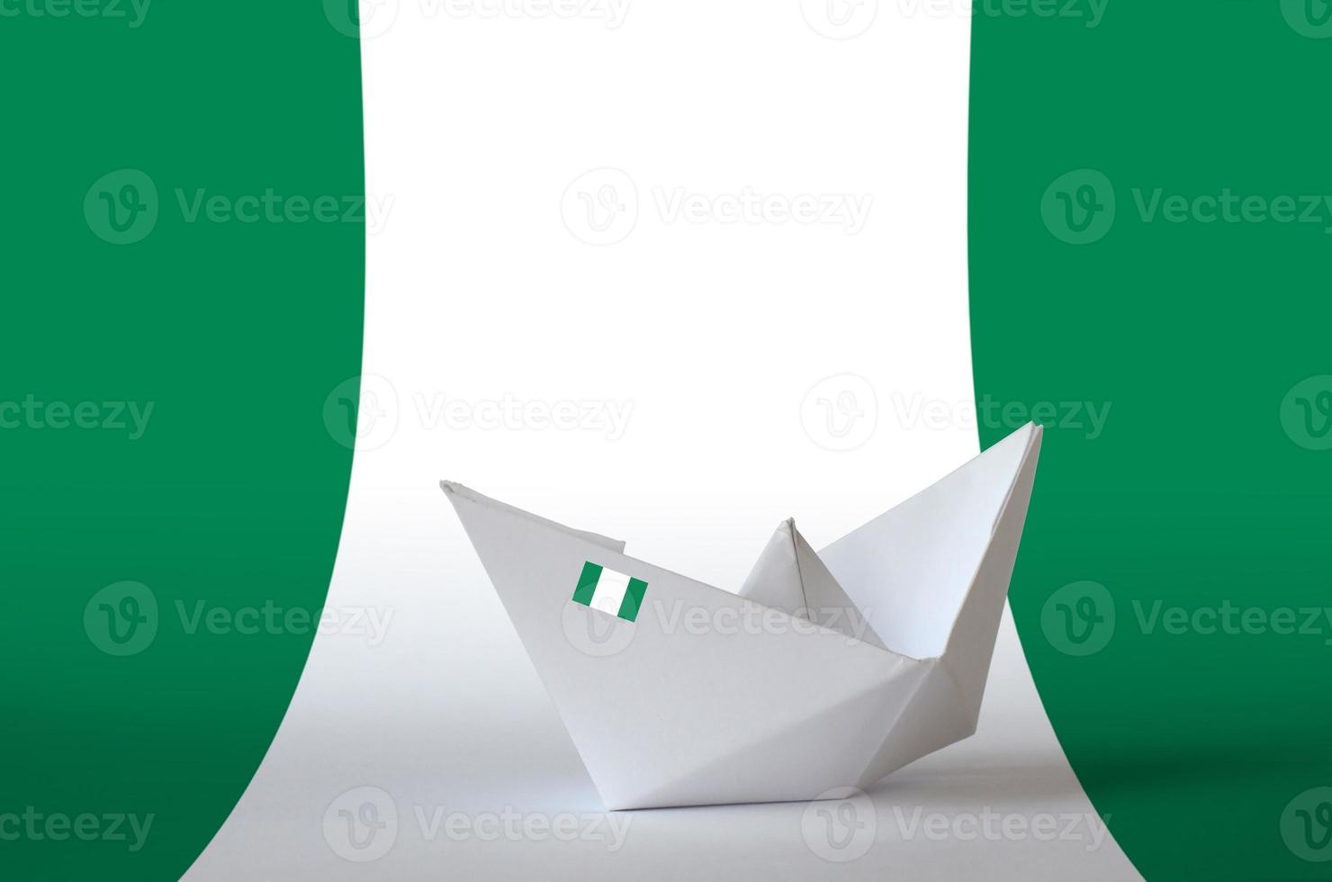 Nigeria flag depicted on paper origami ship closeup. Handmade arts concept photo